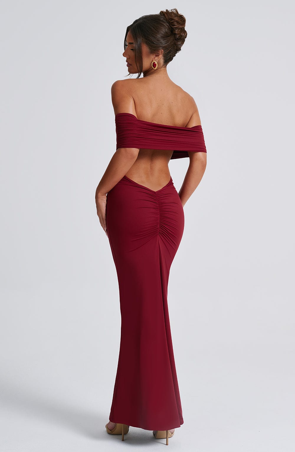 Rear view of the Belinda Maxi Dress highlighting the bold open low-cut back and figure-enhancing ruched detailing
