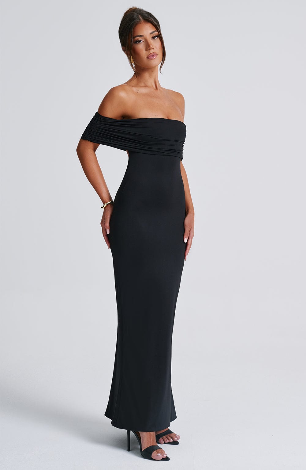 Side profile of the body-contouring Belinda Maxi Dress showcasing the sculpted, double-layered slinky fabric fit.