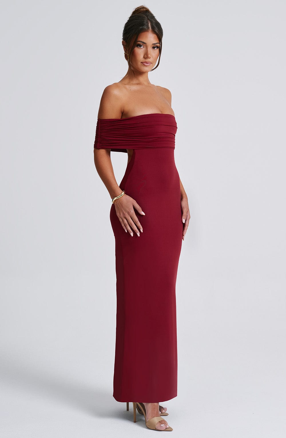 Side profile of the body-contouring Belinda Maxi Dress showcasing the sculpted, double-layered slinky fabric fit.