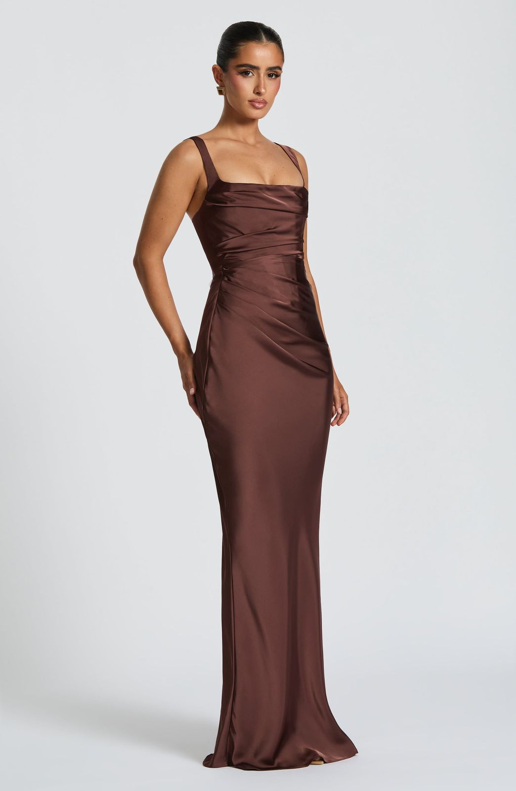 Side profile of the Calanthe Maxi Dress highlighting the asymmetric pleats on the bodice and the flowing maxi dress