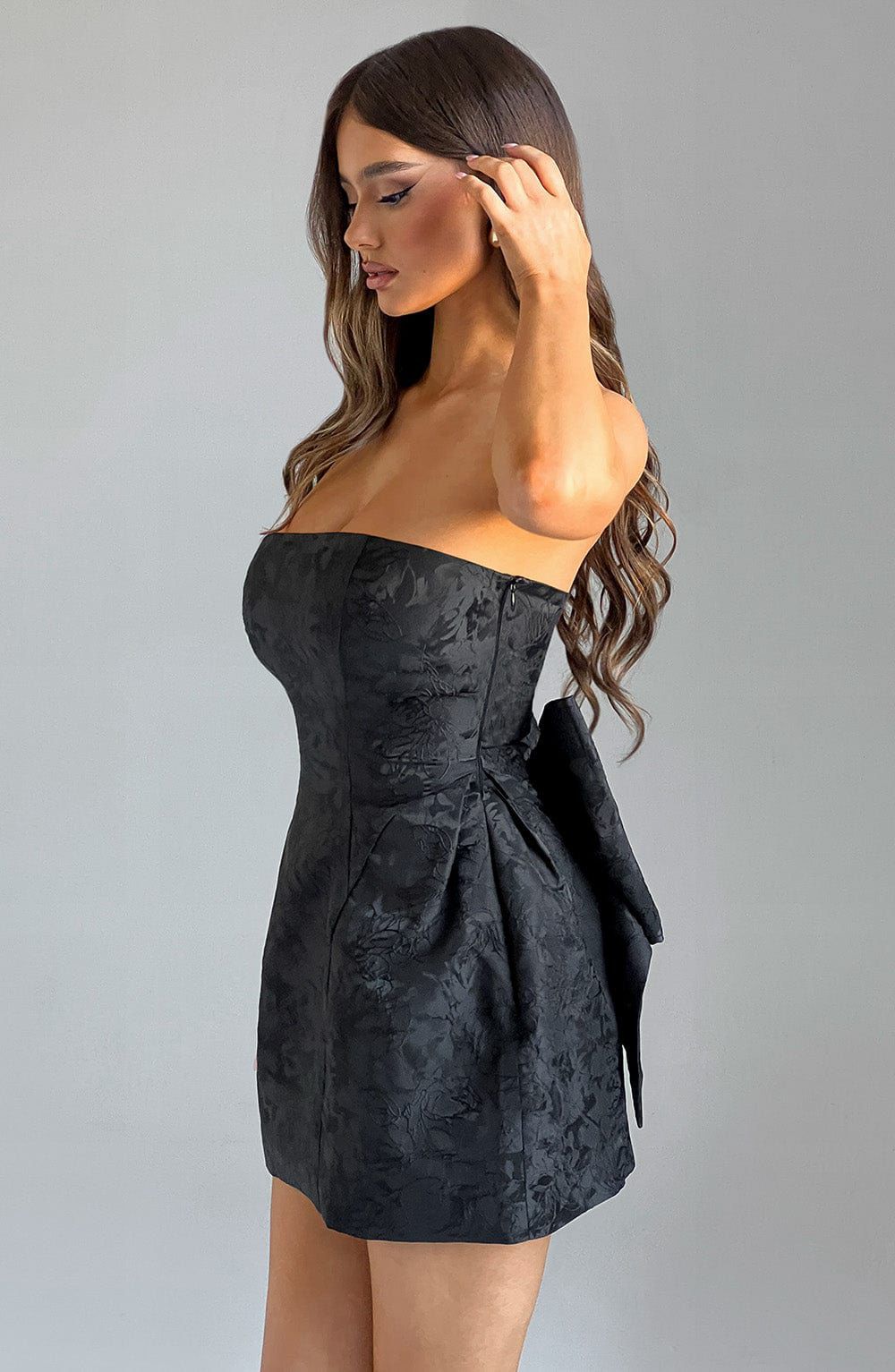 Side profile of the Elenora Mini Dress highlighting the voluminous structured skirt and fitted waist