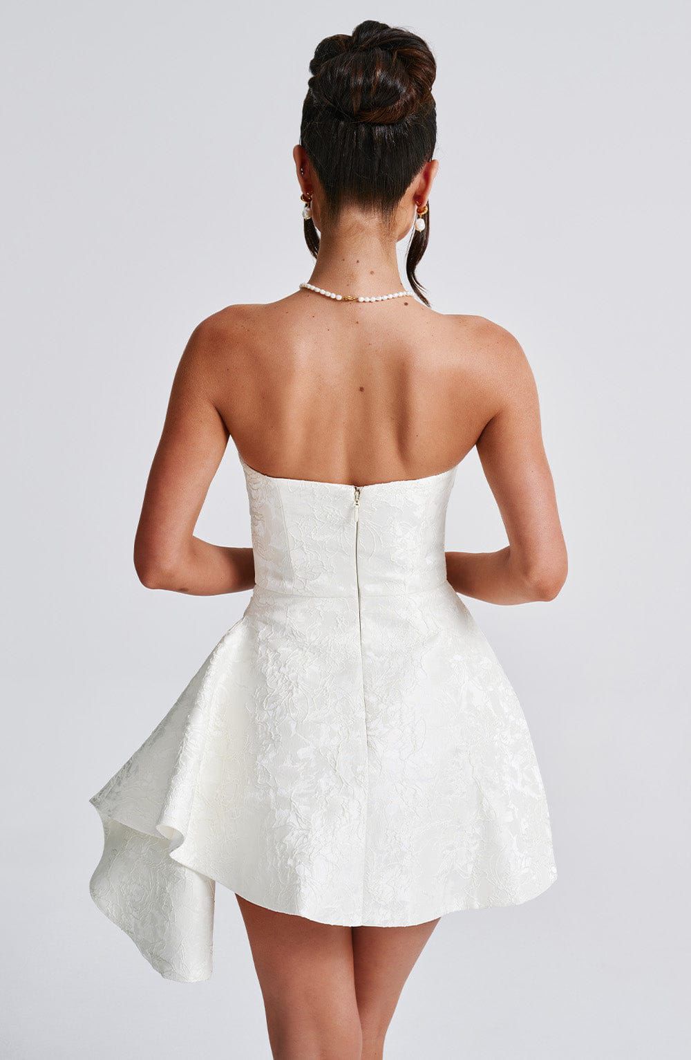 Back view of the Elodie Mini Dress showing the invisible center-back zipper and fitted silhouette