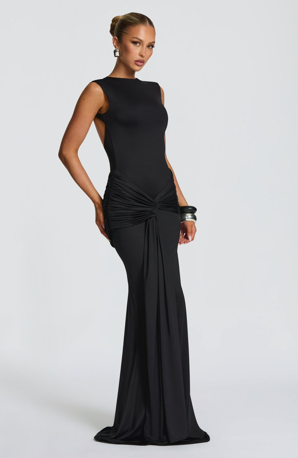 Side profile of the Lorenza Maxi Dress in slinky jersey fabric highlighting the floor-length silhouette