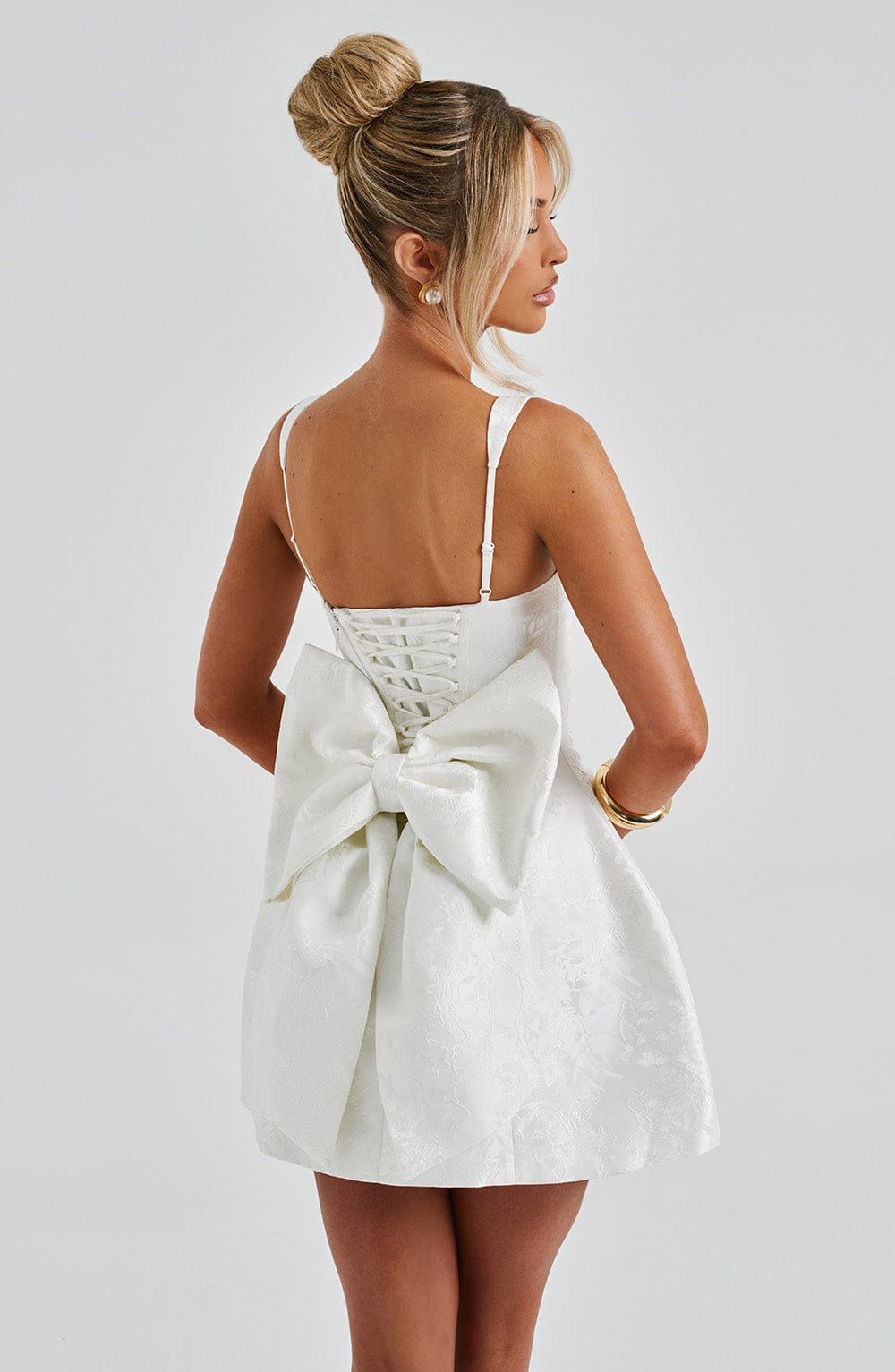 Side profile of Orla mini dress showing figure-hugging fit and trendy mini length style