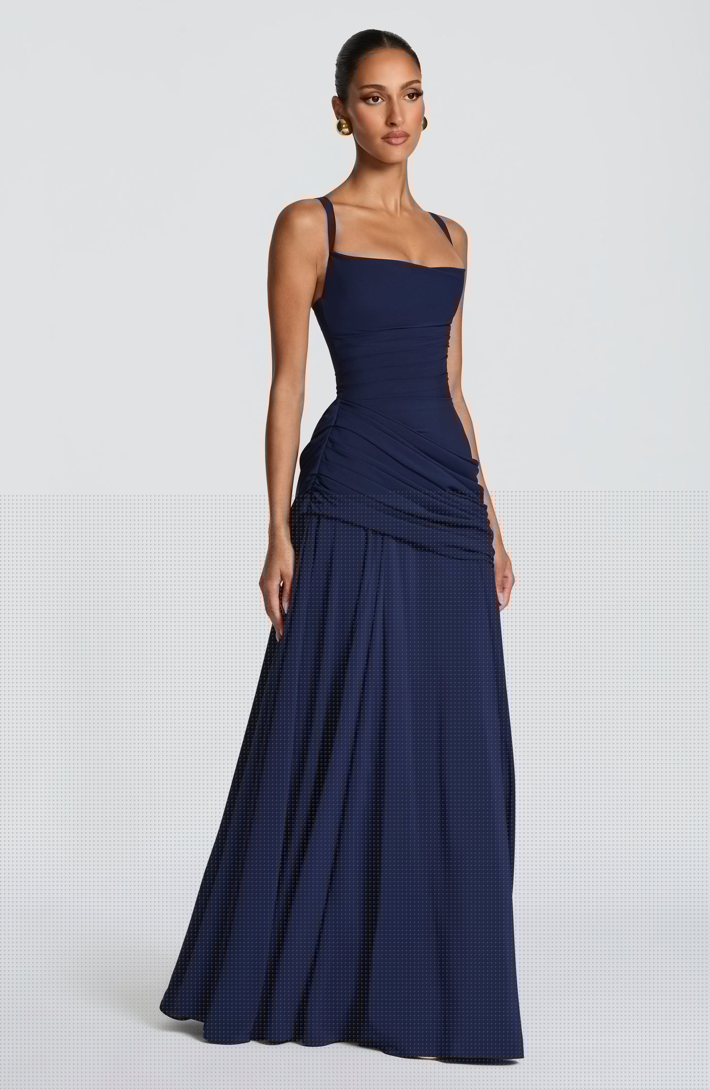 Side profile of the Sura Maxi Dress featuring the draped hip panel and flowing full skirt with godet details for elegant movement.